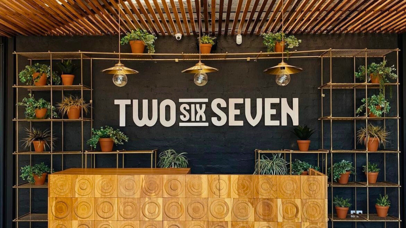 Two Six Seven entrance with brass plant grids and signage